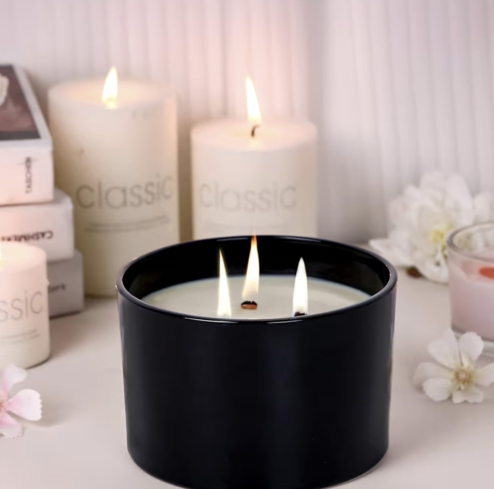 Soy candles of different sizes arranged together on a pale surface